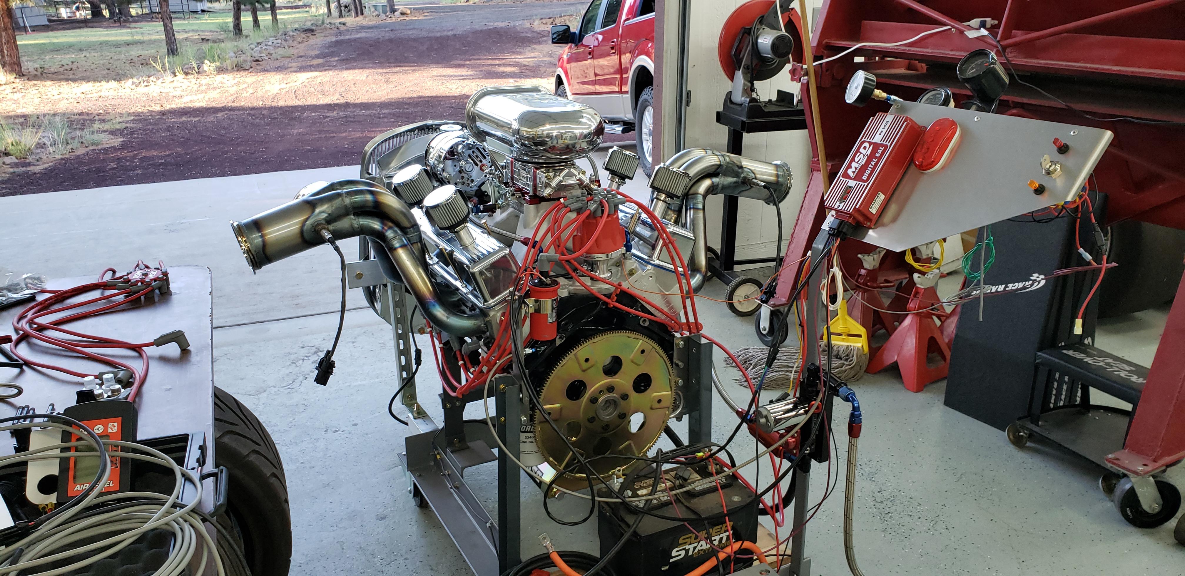 New engine on the test stand.  Getting it ready to fire and check for proper operation before installing it in the car.  Better to catch problems now while it's easier to fix than in the car.  If you notice the mop in the photo -- 1st problem was a leaky radiator hose connection.

Don't have the mufflers made yet but decided to fire it and make sure it runs.  This engine seems twice as loud as the old one so I changed gears and welded up some inserts.  We'll try again tomorrow and maybe I won't need ear plugs anymore.

RIGHT CLICK THEN CLICK VIEW IMAGE