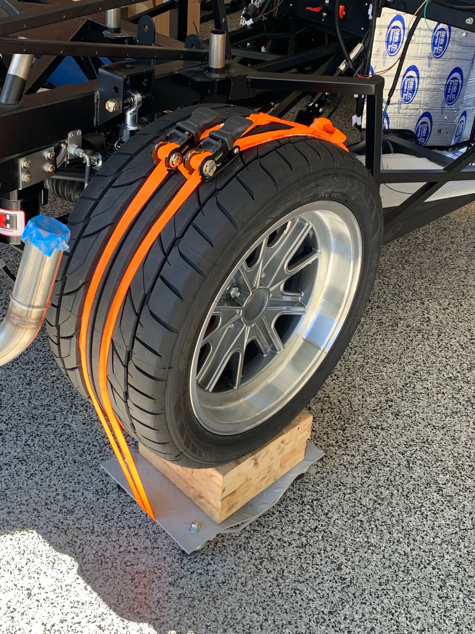 Rear wheel strap down