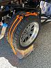 Rear wheel strap down