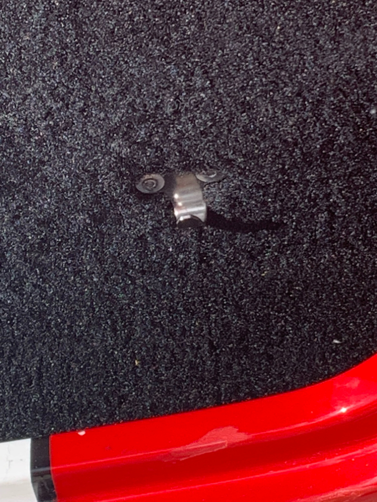 Trunk prop rod holder.