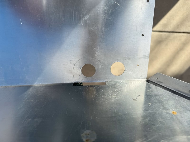 Holes drilled for seat belt bolt access and seat heater wire.