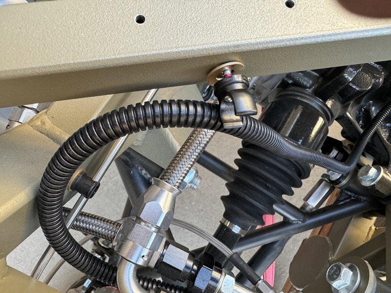 Driver side e-brake wire clipped-in.