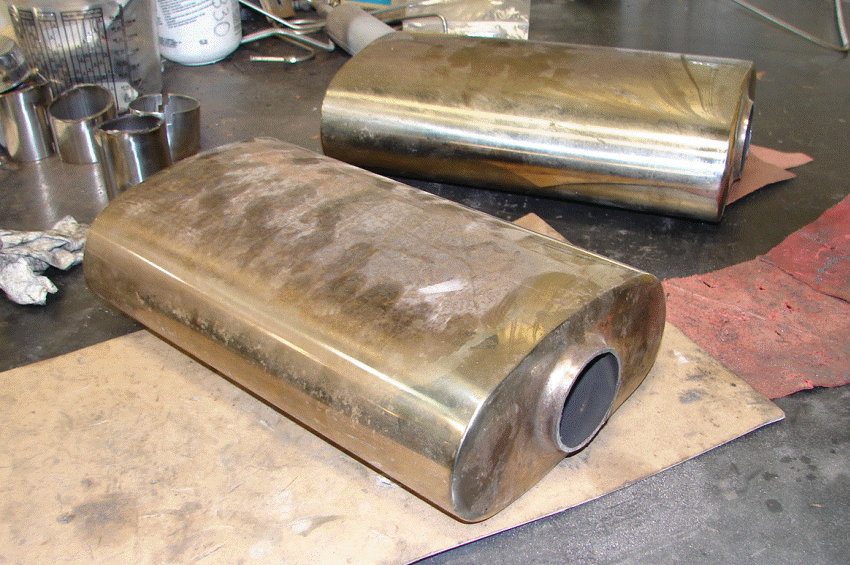 Old FFR Mufflers - We cut off the inlets and outlets and welded them on the new mufflers. The discoloration from heat is evident here. The cans are absolutely empty of anything but the perforated interior pipe. One interior pipe is loose and rattles and both of them are about as effective as an empty one gallon coffee can!