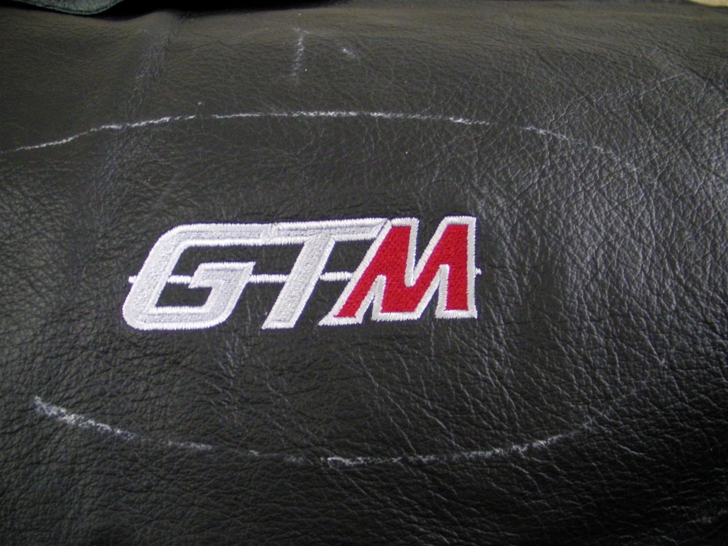 GTM logo sewn into the passanger side dash pod next the air vent. This pic was taken just before the leather was glued onto the pod.