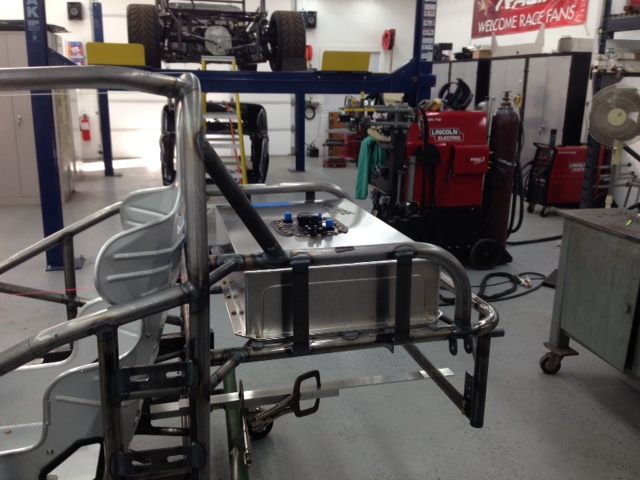 Fuel cell mounted behind tubing for 360-deg crash protection.