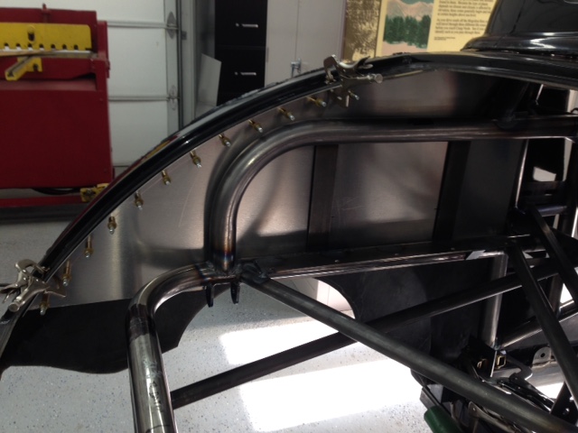 Heat treated aluminum structural panel attaches body to chassis and transfers load from the deck lid spoiler to the chassis.  Also acts as an integral part of the NHRA required rear firewall to separate the fuel cell and battery from the cockpit.