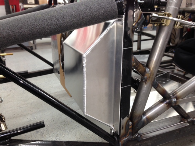 Made a bulge on the driver's side lower firewall to provide room to locate the pedals 5" further forward than the original FFR design.