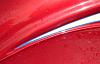 This photo shows the pinstripe detail as well as the fabric "welt" that separates the fender from the body wheel well. Welt is "period correct" for a...