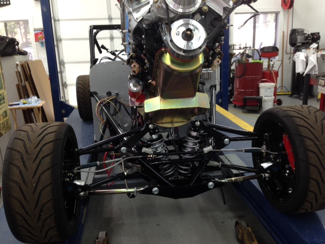 Engine & trans going in again -- this time it should stay for up to two-years when the clutch & flywheel have to be re-certified to SFI specs again.  Going in from the front is easy and a one-man job using a cherry picker and the lift.  But the real key is the articulating engine lift mounted to the carb pad as it allows tilting the engine around obstacles.