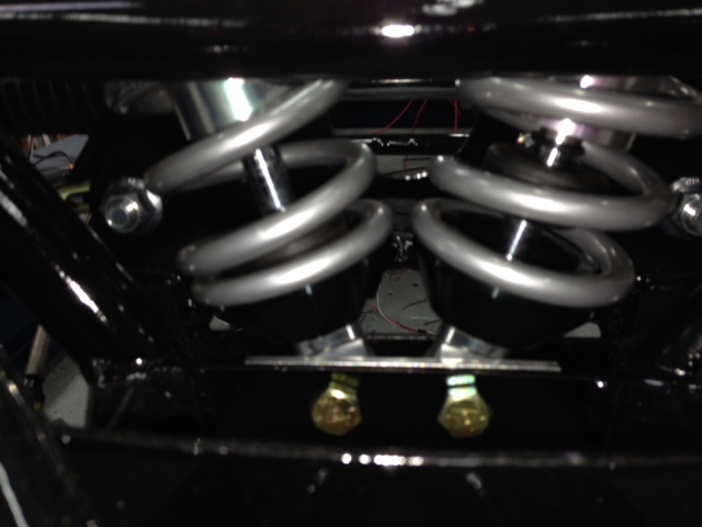 Inverting the QA1 shocks requires longer coil caps to prevent the springs from rubbing each other.