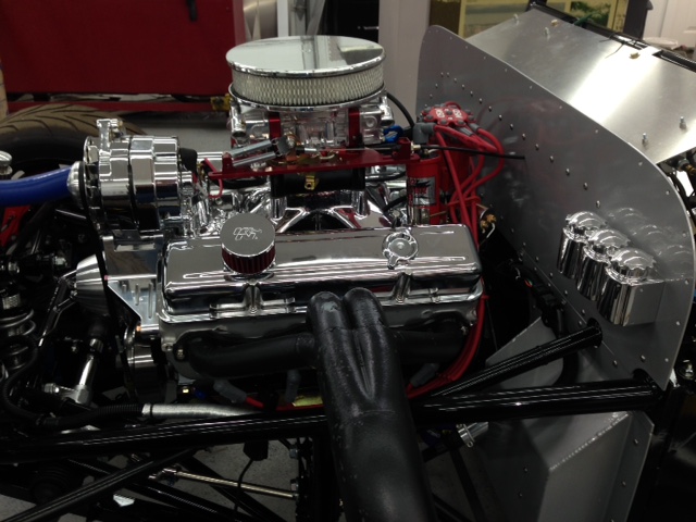 Wired and fired.  Started the engine for the first time in the car.  I had run it on a test stand and tuned the low speed and intermediate circuits and dialed in the distributor advance.  So this was just to set the timing (removed the distributor to prime the oil pump) and check the electrical functionality.

Later I backed the car out of the shop and checked the mufflers as they seemed very loud in the shop.  At 50' and 90-degree from the side of the car I measured 84db at 2500 RPM.  I measured 45db background noise before I started the car.  The car was setting next to a wall on the offside so I'm sure some of the sound from that side was also being reflected to my meter.  Loud yes but I'll take a chance with this noise level as there are many louder bikes running the roads here.  

I could certainly make the mufflers quite but I don't have the means to measure the back pressure and don't want to restrict the exhaust more than necessary.  The baffling I'm using is easily changed with one cap screw and the current configuration has an open area about the size of 3" open exhaust tubing.  So I expect minimum back pressure.

Here's what it sounds like -- highlight & right click to open the link: https://www.youtube.com/watch?v=ipck_944jsM