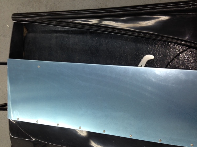 I though about simply leaving the inner door open as this is a race car not a show car.  However, it's easy enough to fabricate some simple aluminum door skins and dress up the interior a bit.  That blue hue is really the protective PVC coating and will be removed once the panel is installed for the last time.  The .032" aluminum adds very little to the weight of the door (about as much as the glass material that was removed) and will be left bare to match the rest of the interior.