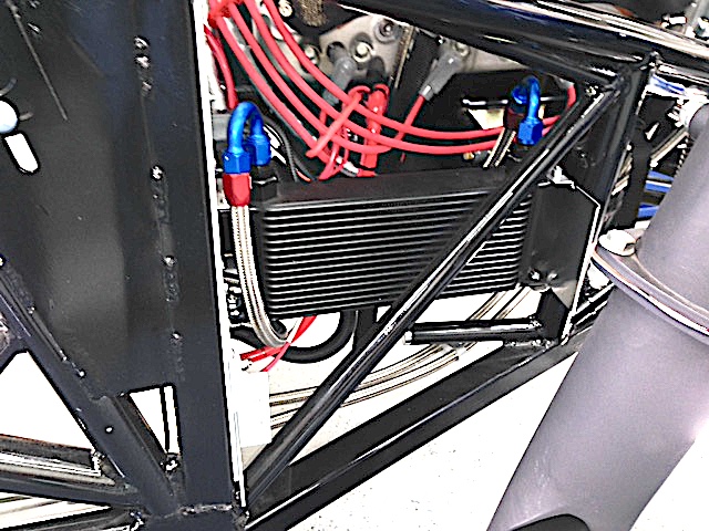 Hughes Performance said I'll need at least a 10,000 BTU/hr cooler for their Pro converter.  The 4500 stall speed creates much more heat than an average street car.  This cooler is 30,000 BTU since I couldn't mount it in a laminar flow airstream.  I also didn't have room for a fan so I designed a spoiler to create some negative pressure on the OB side to induce air flow through the cooler.  The small size and unique shape of this car has been a real challenge to mount everything needed and still make things easily serviceable.