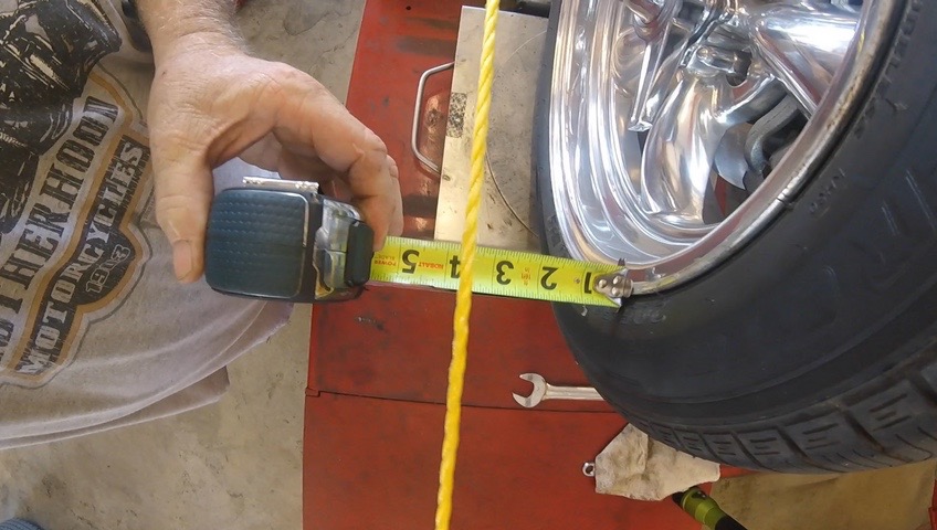 The alignment process with the staggered wheels. Very precise using the straight line from the rear wheel and measuring on the front.