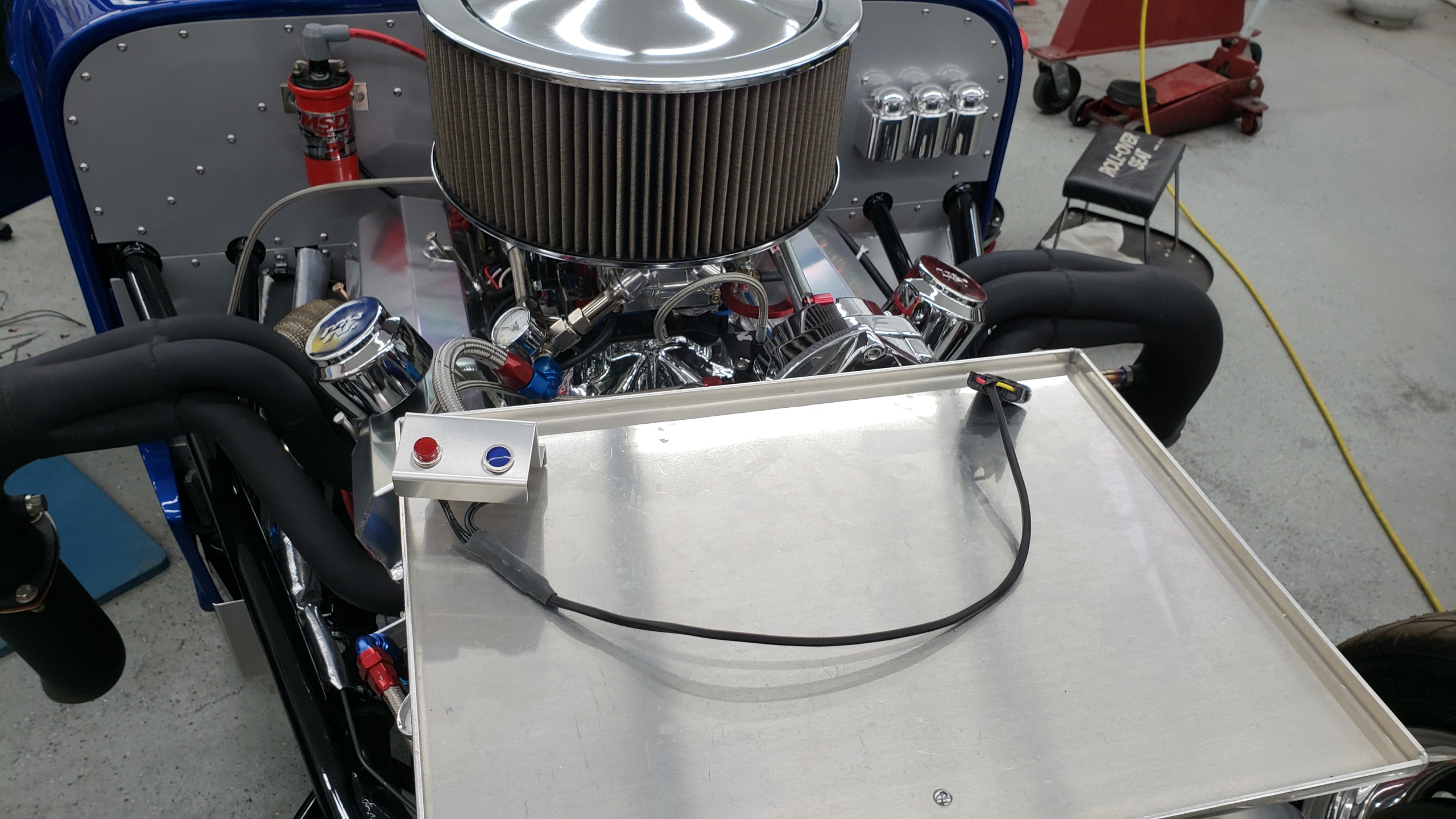 Made a test light panel to test the solenoid function without triggering the solenoids.  Blue is nitrous and red is fuel.  Simply unplug the solenoids (I used GM style Weather Pack connectors) and plug in the test lights and the controller triggers these same as it would the solenoids.

Makes it easy to see if the controller is firing and modulating the solenoids as I programmed it to.  You can see the lights blink as the controller modulates the opening and closing of each solenoid 18 times a second during the ramp and then steady on once at 100%.

Made the bracket so it fits under the lip of the air cleaner so I can mount it where I can see the lights while driving and I can test drive the system without spraying nitrous and fuel just to make sure everything acts as it should before running the system "hot".

I put on the mufflers and street tires (my street tires are 16" wide DOT drag radials) so I could test drive it before taking it to the last test & tune this FRI.  But there is so much ice and snow at the old rancho that I can't even get the car out of my driveway or load the car into the trailer.  So looks like the car will sit in the shop until the snow melts.